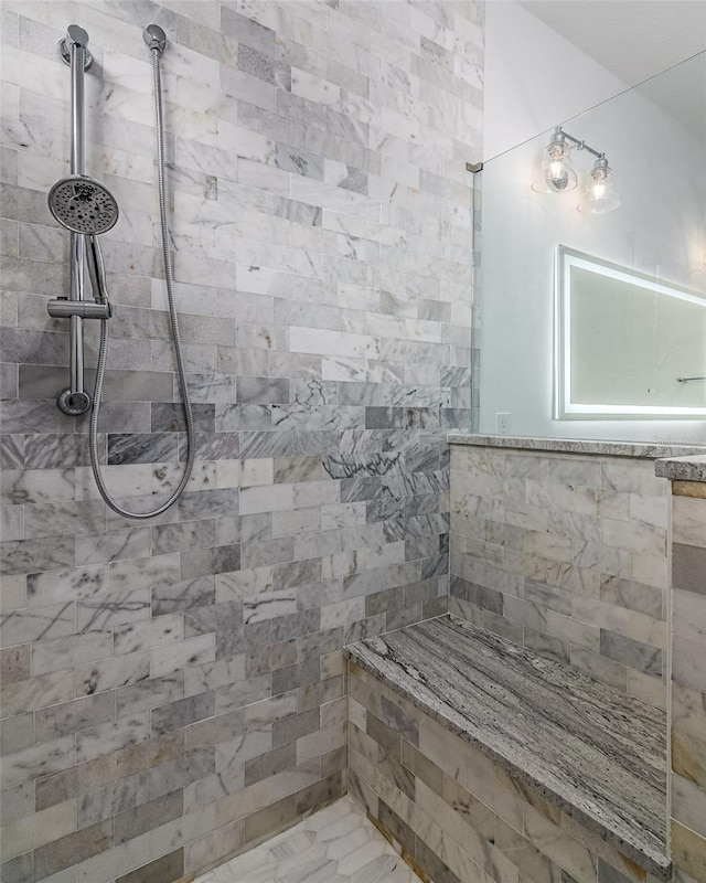 bathroom featuring tiled shower