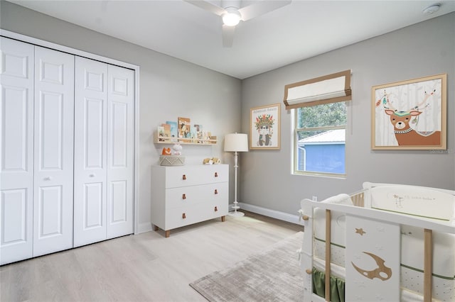 bedroom featuring a closet, light hardwood / wood-style flooring, and ceiling fan