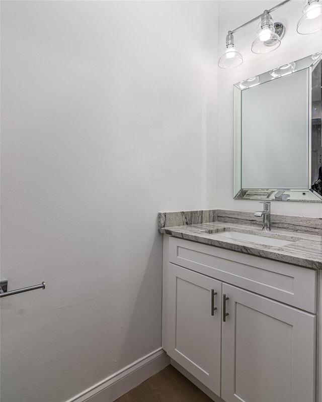 bathroom featuring hardwood / wood-style flooring and vanity