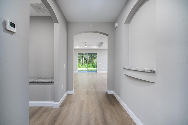 hallway with light hardwood / wood-style floors