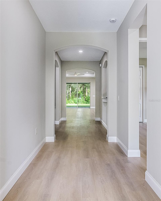 hallway with light hardwood / wood-style floors