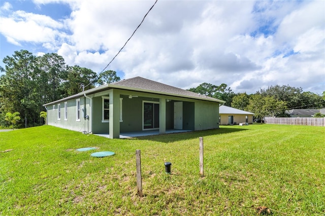 back of house featuring a yard and a patio