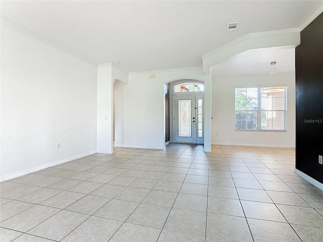 3623 Weatherfield Dr, Kissimmee, FL 34746 - foyer entrance featuring visible vents, arched walkways, light tile patterned flooring, and ornamental molding