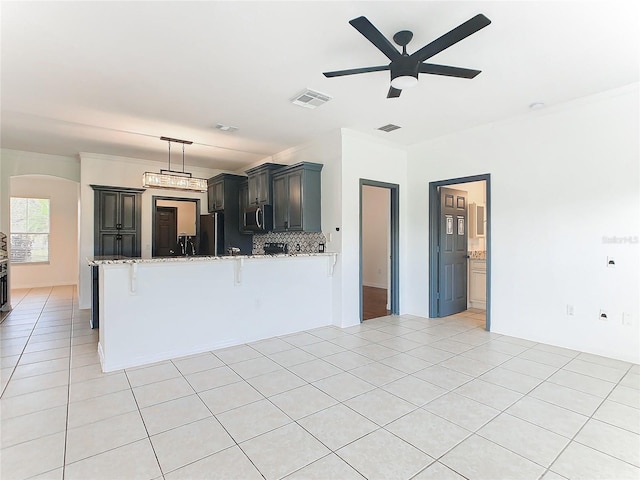 3623 Weatherfield Dr, Kissimmee, FL 34746 - unfurnished living room with visible vents, arched walkways, a ceiling fan, and light tile patterned flooring