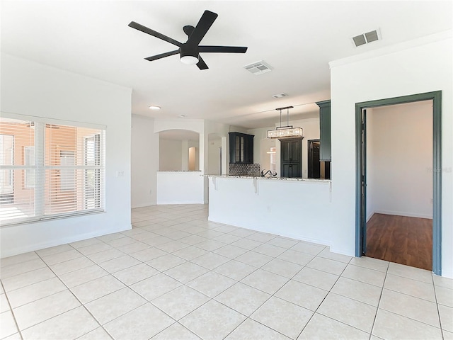 interior space with ceiling fan and light tile patterned floors