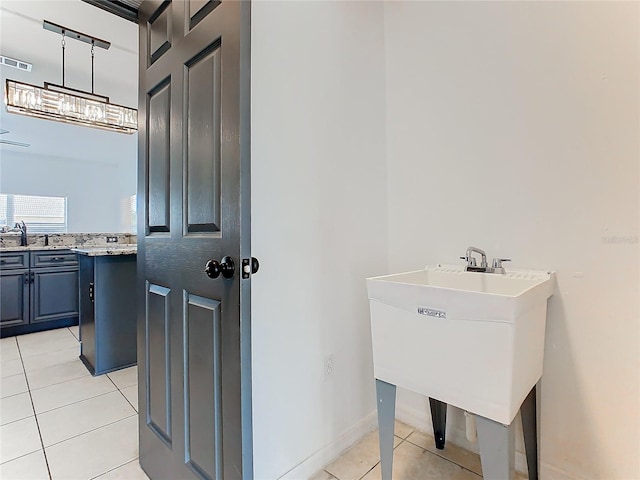 3623 Weatherfield Dr, Kissimmee, FL 34746 - bathroom with baseboards, tile patterned flooring, vanity, and visible vents