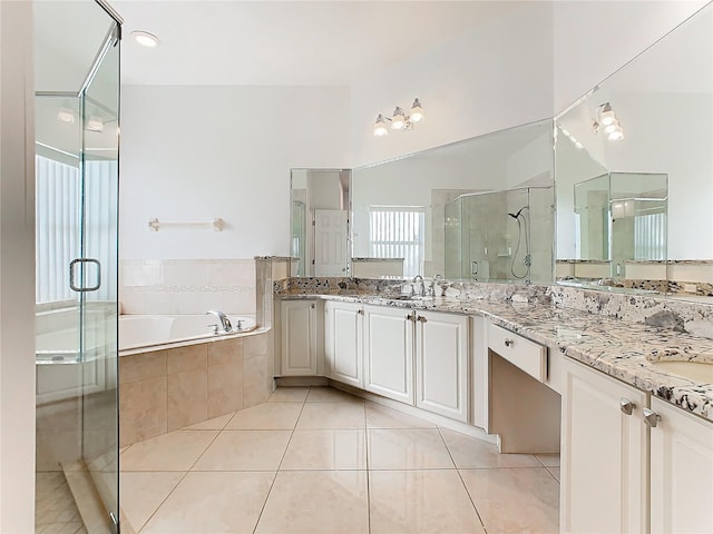 3623 Weatherfield Dr, Kissimmee, FL 34746 - bathroom featuring double vanity, a garden tub, a shower stall, a sink, and tile patterned floors