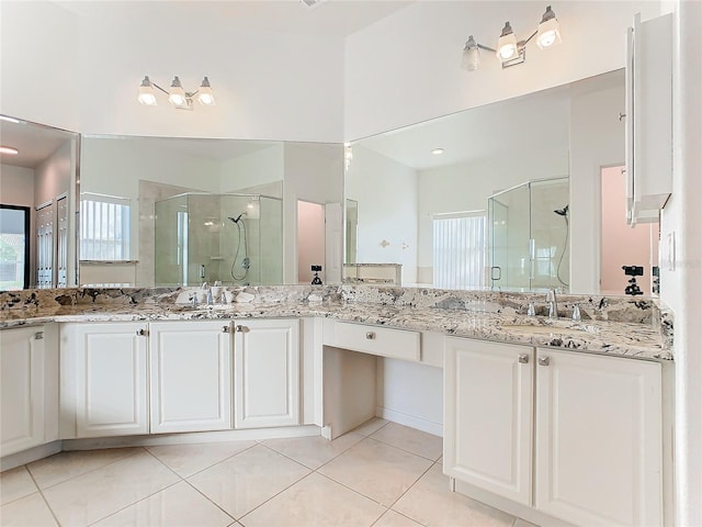 bathroom with vanity, tile patterned floors, and a shower with shower door