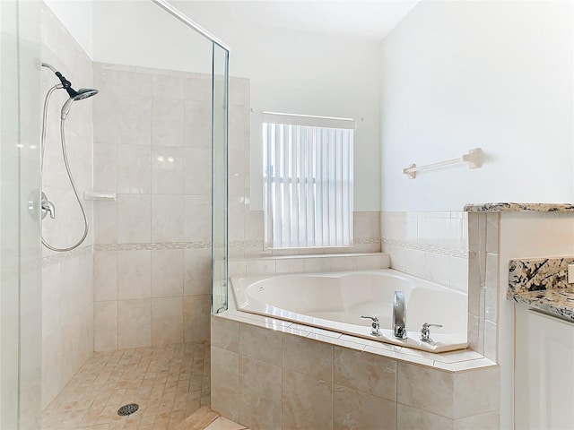 bathroom with vanity and independent shower and bath