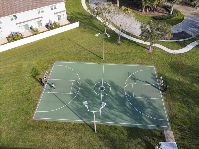 view of sport court with a lawn