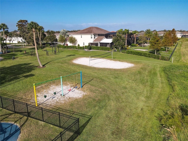 surrounding community with a yard, volleyball court, and a playground