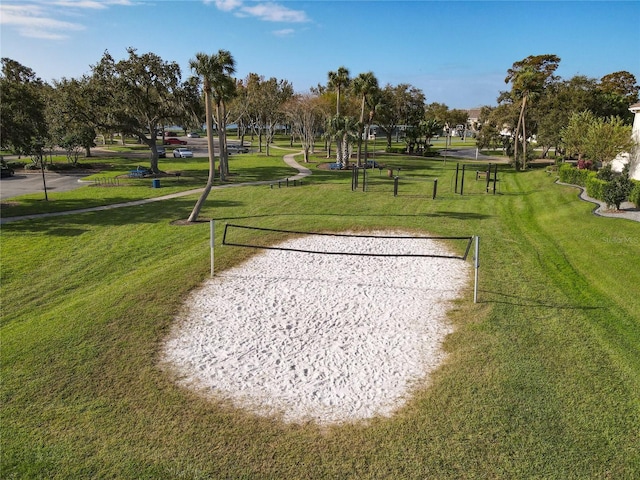 surrounding community featuring a yard and volleyball court