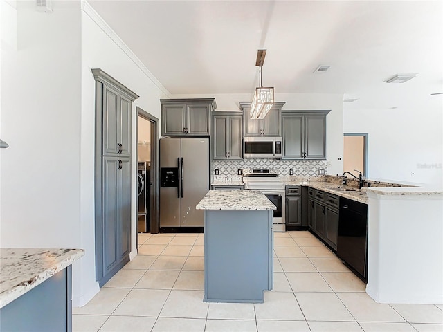 3623 Weatherfield Dr, Kissimmee, FL 34746 - kitchen featuring gray cabinets, appliances with stainless steel finishes, a center island, tasteful backsplash, and a sink