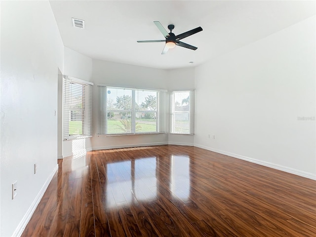 unfurnished room featuring dark wood-type flooring and ceiling fan