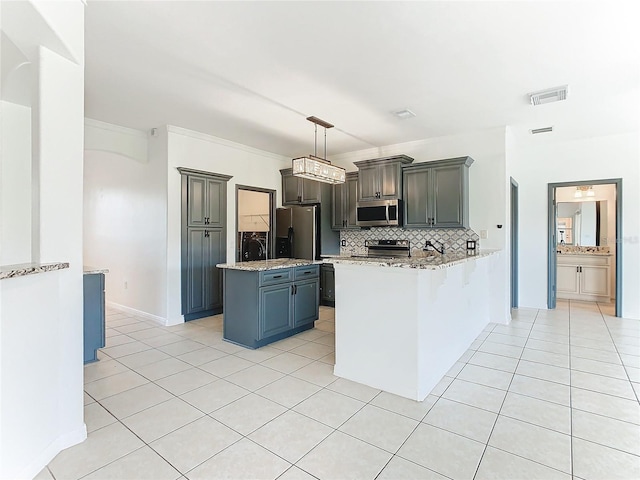 kitchen featuring decorative backsplash, kitchen peninsula, decorative light fixtures, light tile patterned floors, and appliances with stainless steel finishes