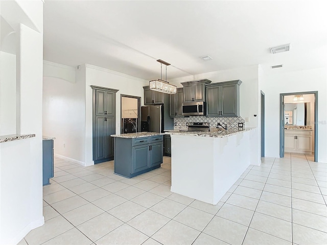 3623 Weatherfield Dr, Kissimmee, FL 34746 - kitchen with visible vents, appliances with stainless steel finishes, light tile patterned floors, and tasteful backsplash