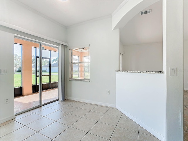 3623 Weatherfield Dr, Kissimmee, FL 34746 - empty room with visible vents, ornamental molding, baseboards, arched walkways, and light tile patterned floors