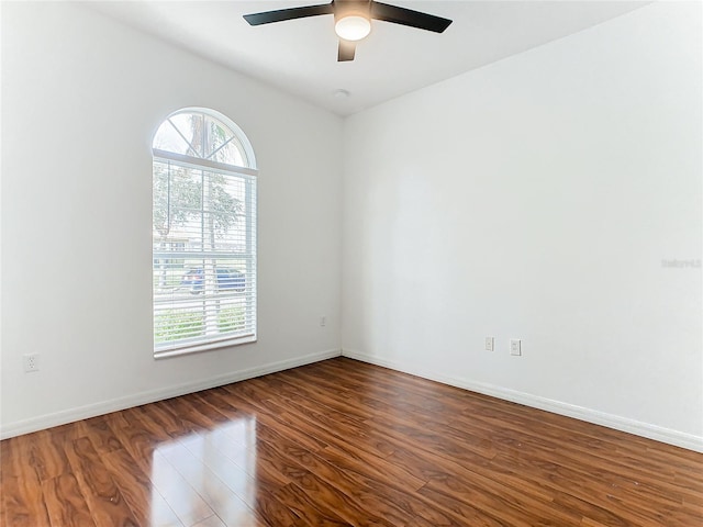 unfurnished room with hardwood / wood-style floors, ceiling fan, and a wealth of natural light