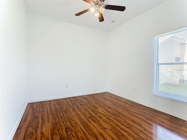 spare room with a healthy amount of sunlight, wood-type flooring, and ceiling fan