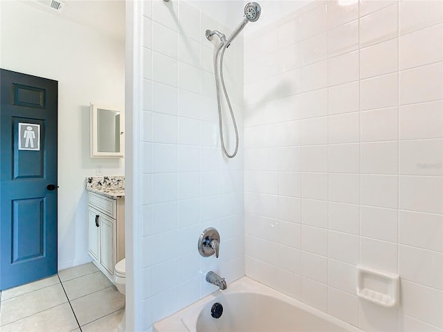 full bathroom featuring vanity, toilet, tiled shower / bath combo, and tile patterned flooring