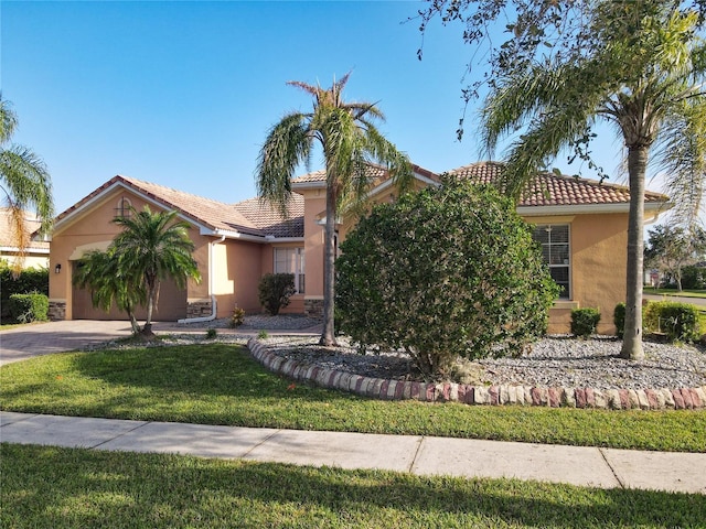 3623 Weatherfield Dr, Kissimmee, FL 34746 - view of front of property with a garage, a front yard, stucco siding, a tiled roof, and concrete driveway