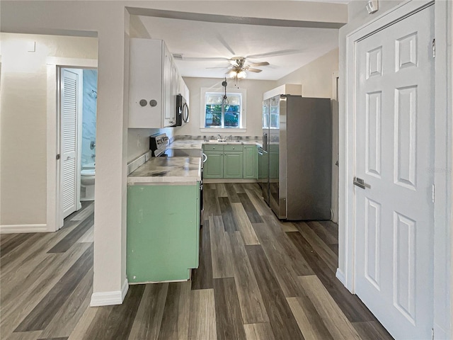 kitchen with ceiling fan, appliances with stainless steel finishes, dark hardwood / wood-style flooring, sink, and green cabinets