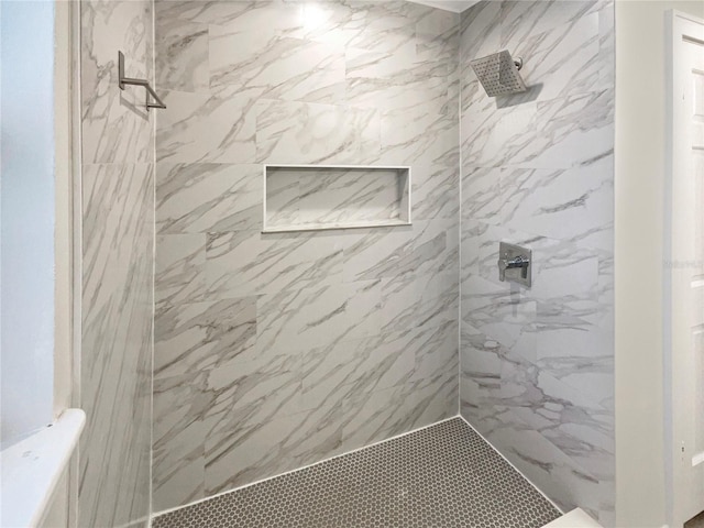 bathroom with a tile shower