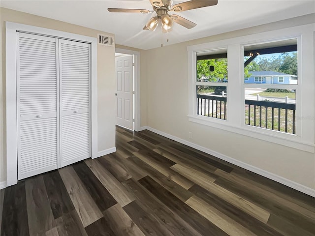 unfurnished bedroom with a closet, ceiling fan, and dark hardwood / wood-style floors