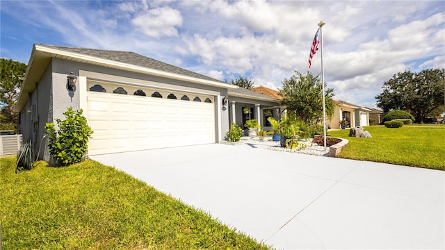 ranch-style house featuring a garage and a front lawn