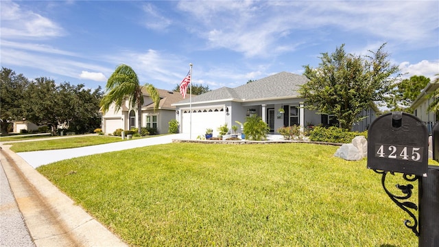 view of front of house with a garage and a front yard