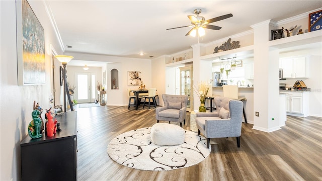 living room featuring ceiling fan, ornamental molding, and hardwood / wood-style flooring