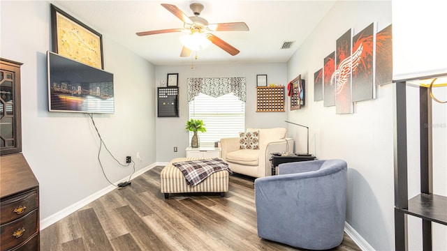 living area featuring hardwood / wood-style flooring and ceiling fan