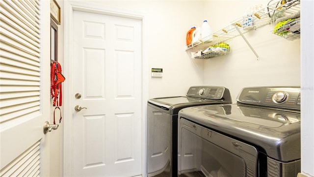 clothes washing area featuring separate washer and dryer