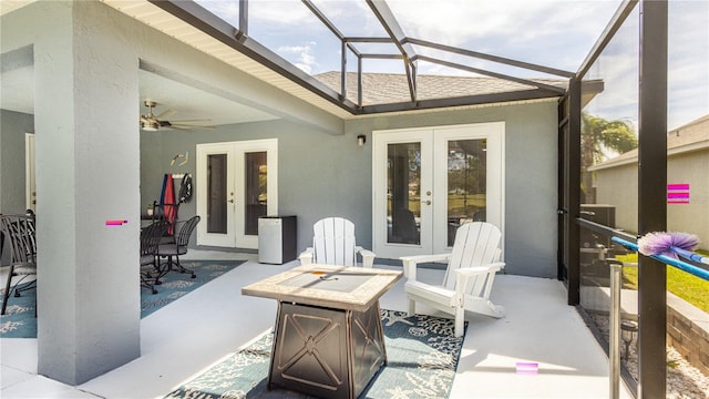 view of patio / terrace featuring glass enclosure, ceiling fan, and french doors