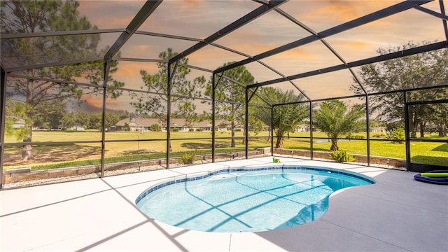 pool at dusk featuring a lanai and a patio