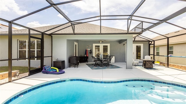 view of swimming pool featuring ceiling fan, a lanai, a patio, and french doors