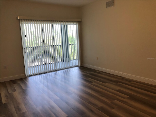 spare room with dark hardwood / wood-style flooring