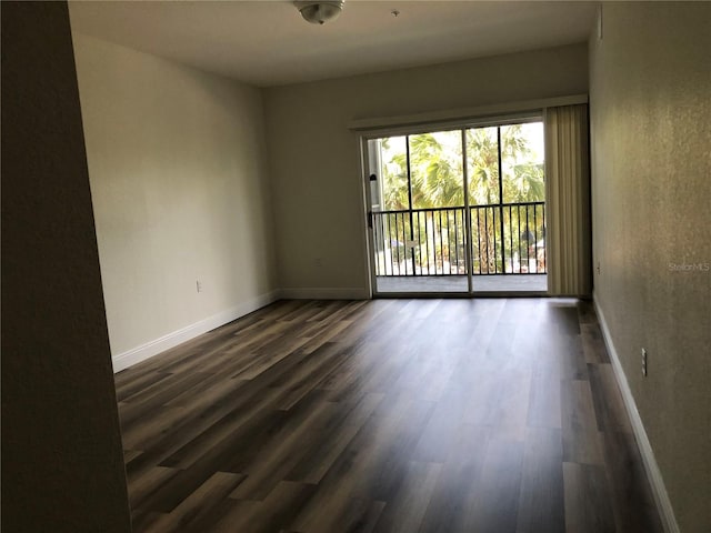 empty room featuring dark hardwood / wood-style flooring