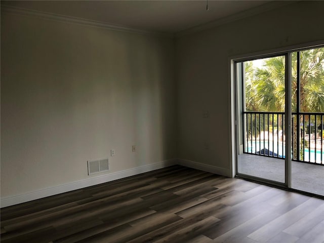 empty room featuring ornamental molding and hardwood / wood-style floors