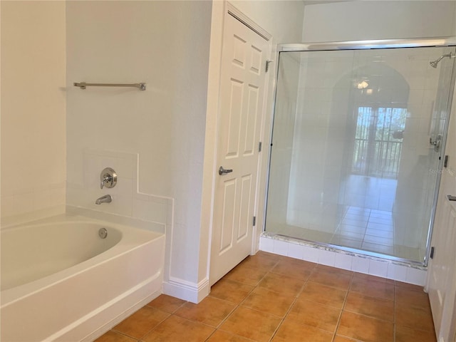 bathroom featuring tile patterned floors and shower with separate bathtub