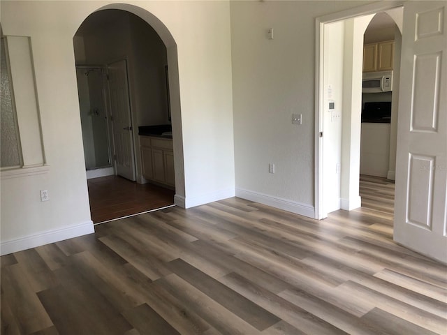 empty room featuring dark wood-type flooring