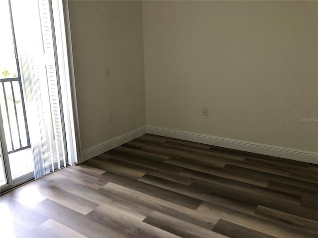 empty room with dark wood-type flooring