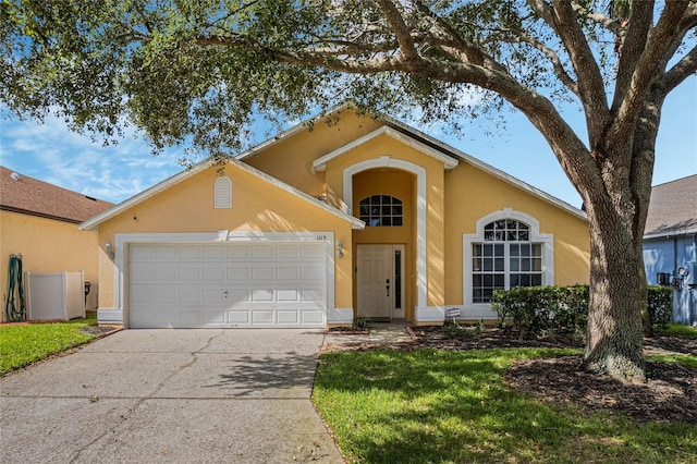 view of front of house with a front lawn and a garage