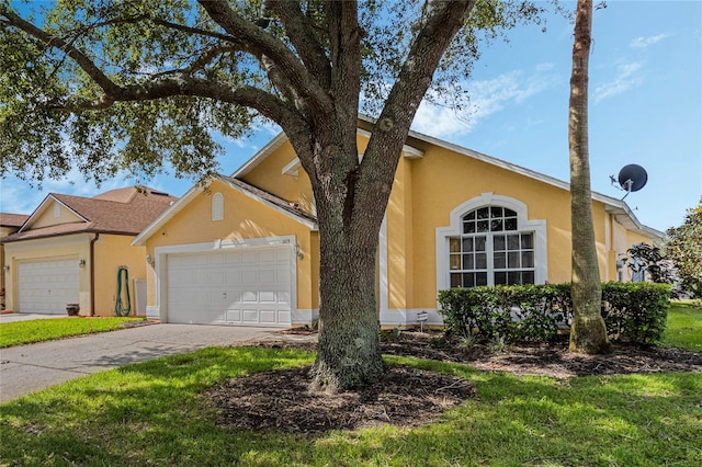 ranch-style house featuring a front lawn and a garage