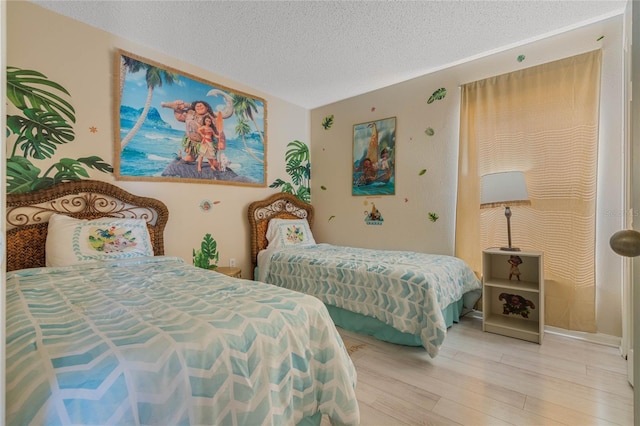 bedroom featuring a textured ceiling and wood-type flooring