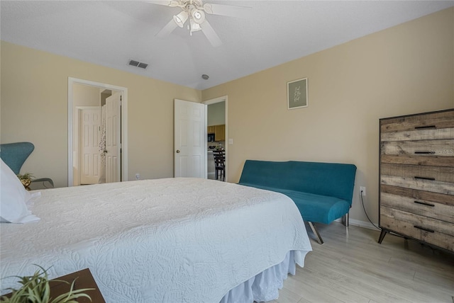 bedroom with ceiling fan and light wood-type flooring