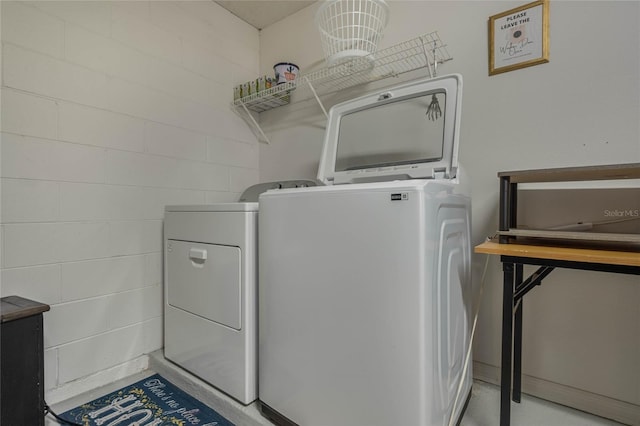 clothes washing area with independent washer and dryer