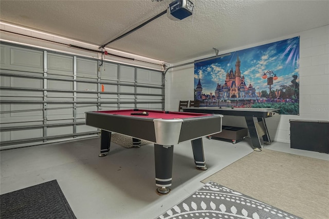 playroom featuring billiards, a textured ceiling, and concrete floors