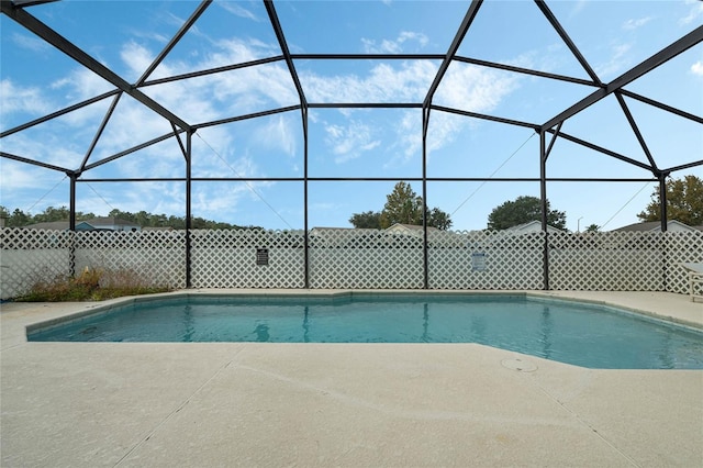 view of swimming pool with a patio and glass enclosure