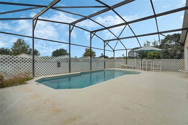 view of swimming pool with a patio and a lanai